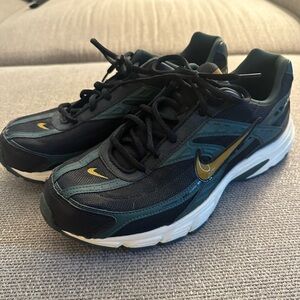 Nike Black and Teal Running Shoes with Gold Accents